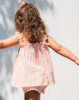 Child in a pink and white striped set