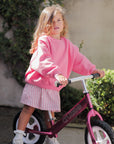 girl wearing the poppy stripe dress and the poppy frankie jumper