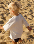 Child playing on a sandy beach