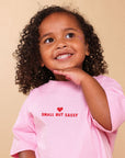 Girl wearing lolly pink tee that says Small But Sassy