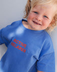 Child wearing a blue shirt with 'ACTIVE RELAXER' text on a plain background