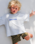 Child wearing a white t-shirt with 'BOOK LOVER' text on a white background