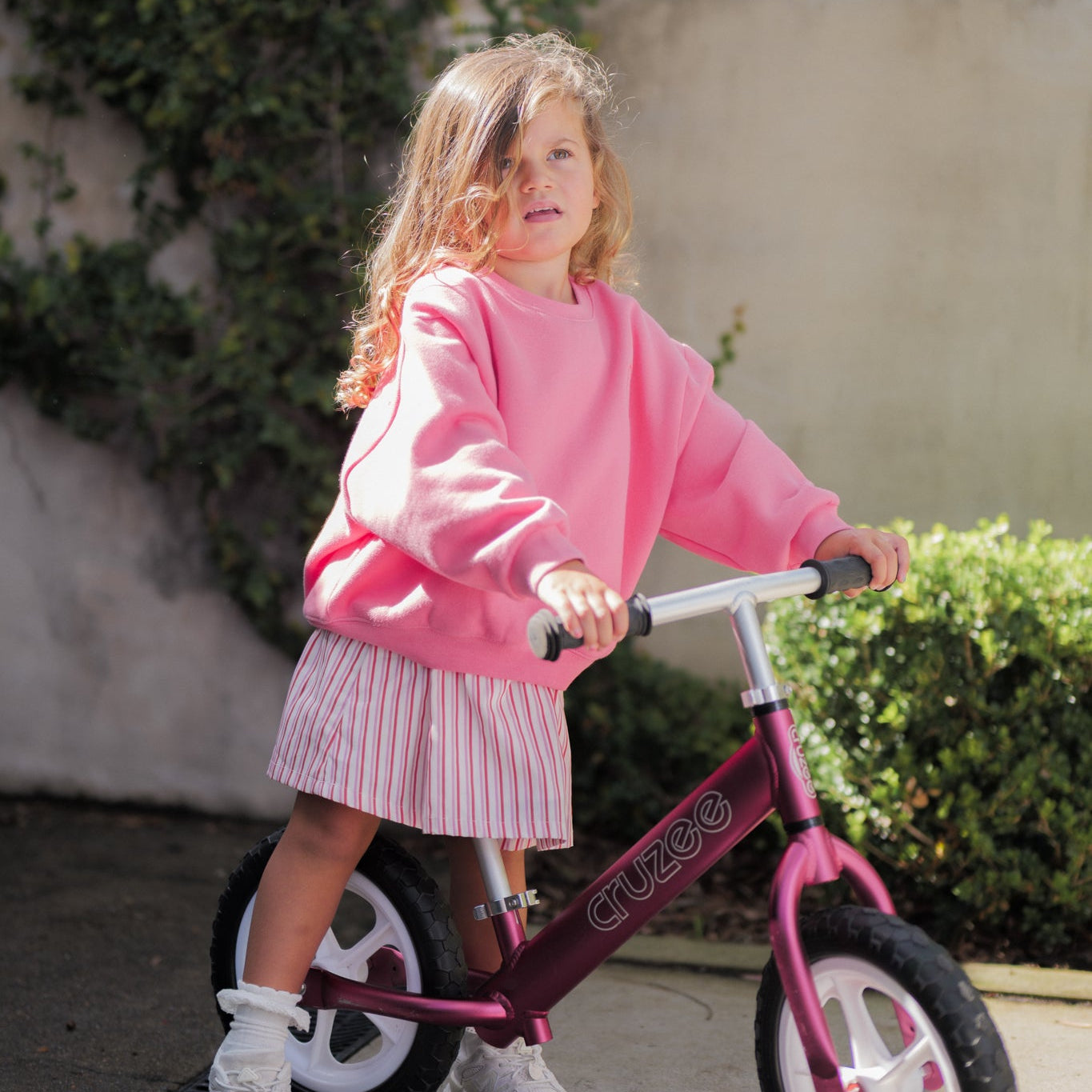 girl wearing the poppy stripe dress and the poppy frankie jumper