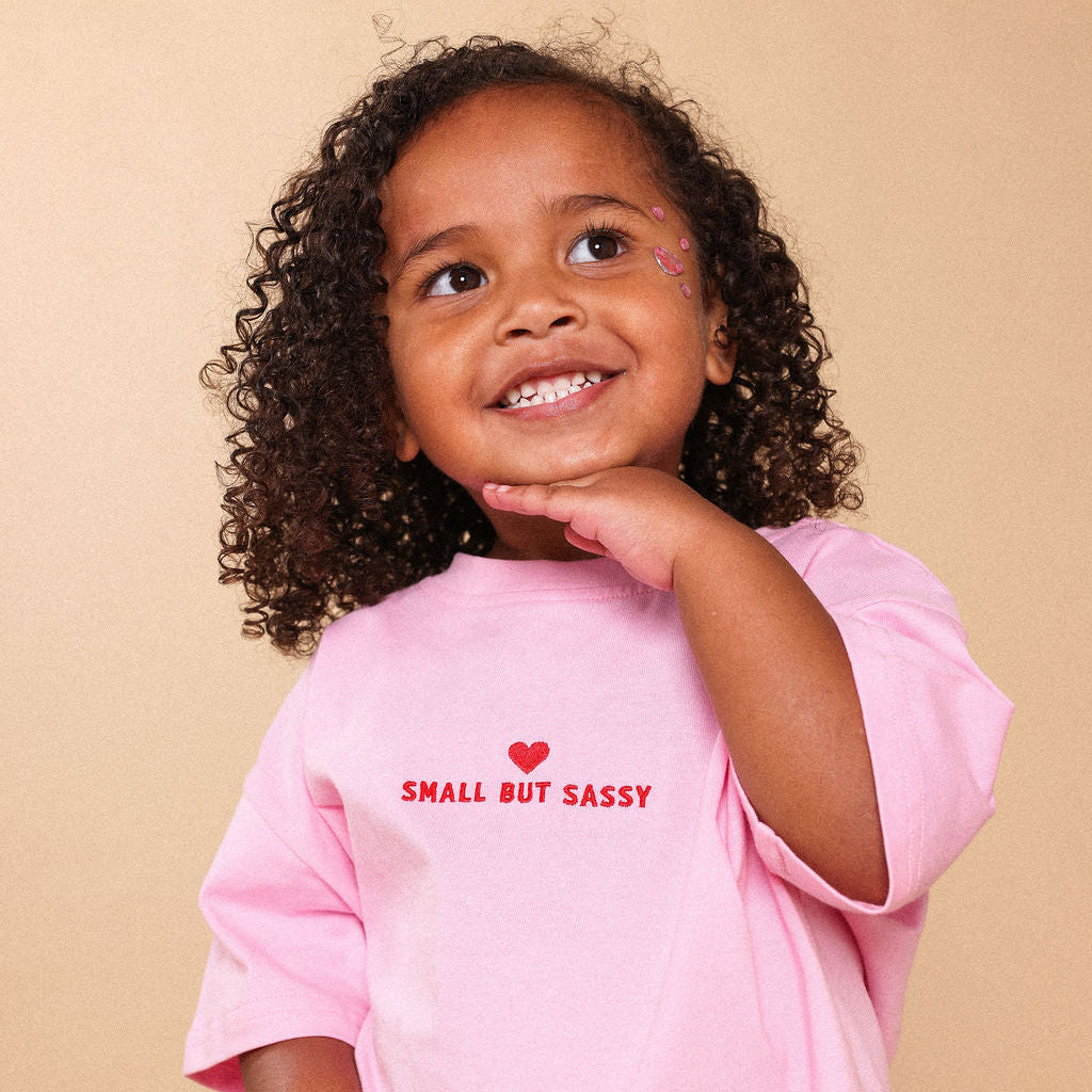 Girl wearing lolly pink tee that says Small But Sassy