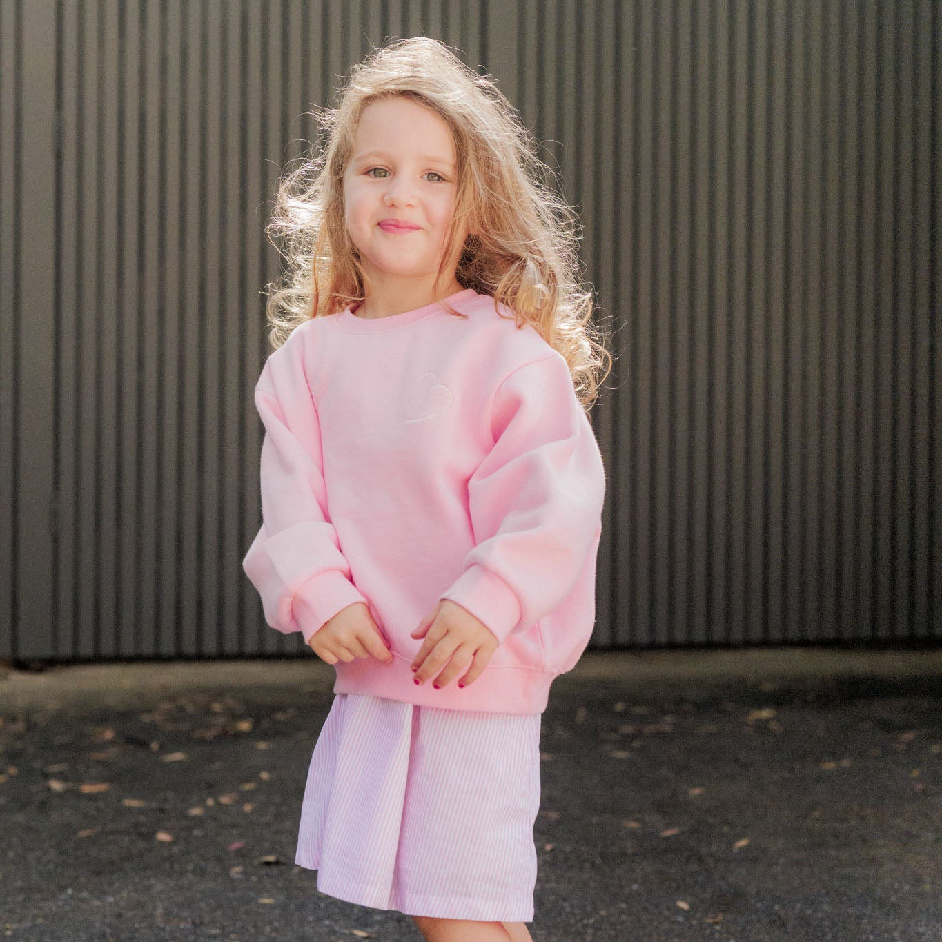 Frankie Jumper in blush pink worn over the dress